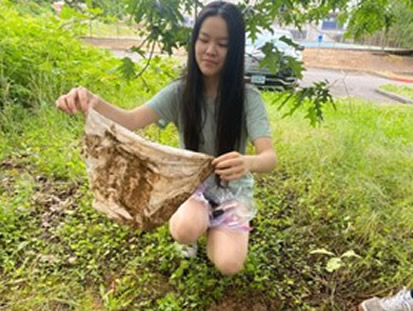 Young woman looking at undies that were buried for 2 months.